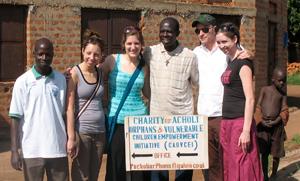 Members of Peace Together Uganda with the program manager and Father Leonsyo Akena.