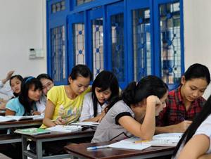 Students in Swift's classroom at Quy Nhon University work on a class assignment together. Concepts of personal space are different in Vietnam than in the United States.
