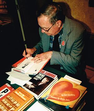 Professor emeritus of English George Hendrick signed copies of 'Poems for the People' during the 1999 Sandburg Days Festival in Galesburg, Ill. Hendrick and his late wife, Willene, edited and wrote an introduction for the book of unpublished poems by Carl Sandburg.