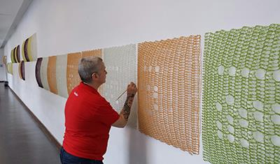 Yvette Kaiser Smith, of Chicago, installs 'Lifesaver Movement in e' in the second floor of Lincoln Hall. Her work is part of the state Art-in-Architecture Program to include art in public buildings.