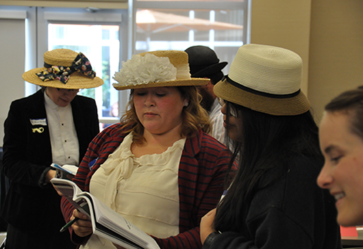 Raquel Escobar, center, with Christine Peralta, right, both graduate students in history at Illinois, portray 1913 feminist activists in Greenwich Village during a 