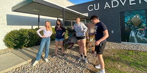 Students outside CU Adventures