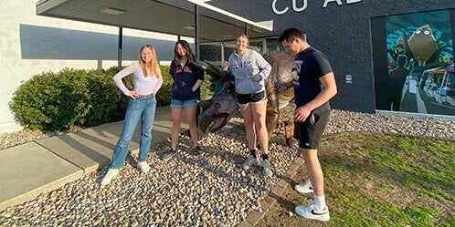 Students outside CU Adventures