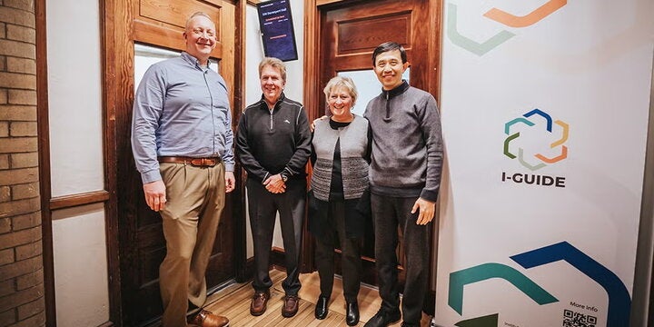 Four individuals pose by the new I-GUIDE Lab