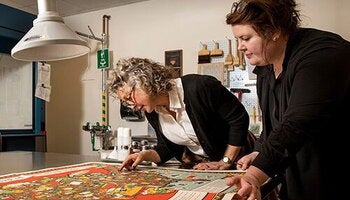 Faculty examine a map