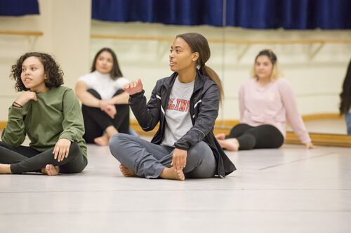 AAP students talk during a dance class on campus