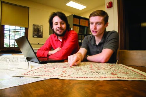 Students look at a map in the campus archives.