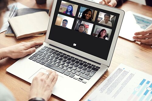 A student uses a computer with a number of smiling faces on the screen