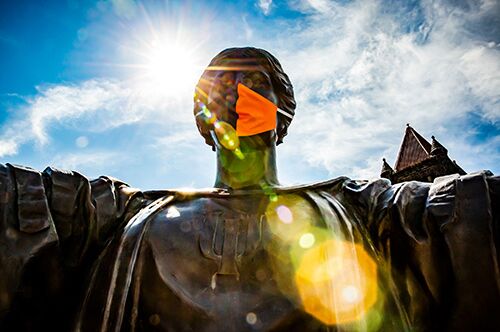 Alma Mater wearing a mask