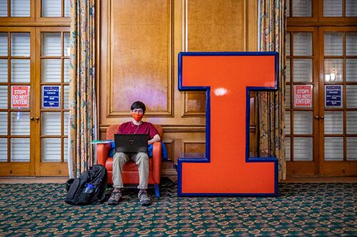 A student works on his computer in the Illini Union