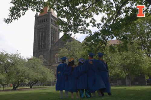 Grads stand in front of Altgeld Hall in regalia