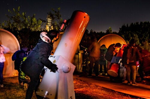 A student looks through a telescope