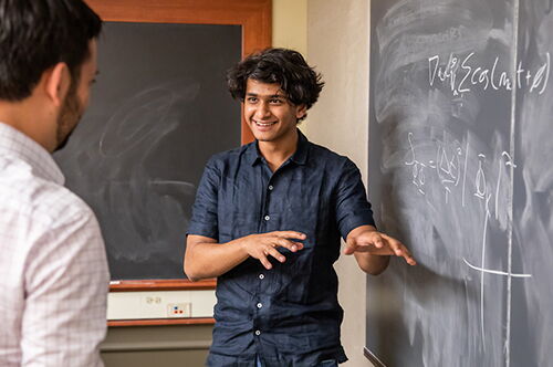 A physics student at a blackboard