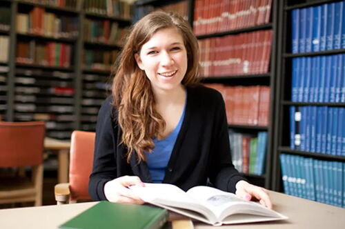 A student looks at a book