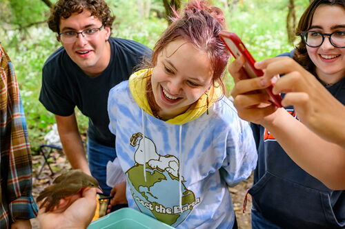 Students look at a bird