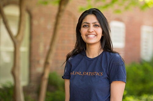 A girl in a statistics tshirt poses for a photo