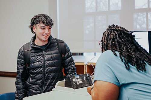 An Access and Achievement Program student talks to an AAP advisor