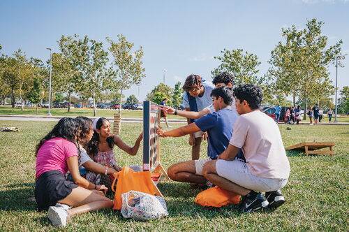 Students playing a game on the grass at LAS Liftoff