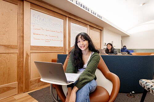 Student siting at a desk at the LAS Lisnek Hub