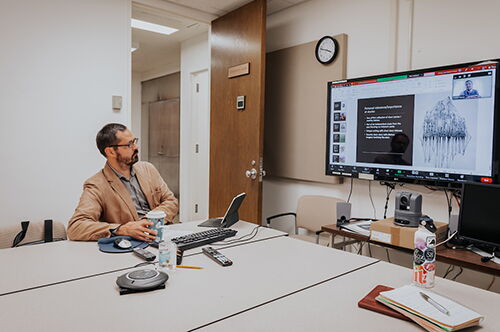 A professor connects to a Zoom meeting during a class