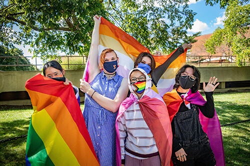 Students holding pride flags