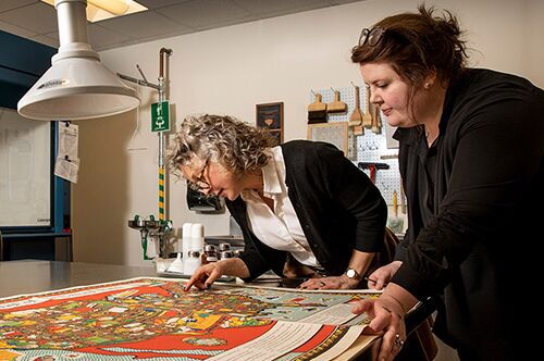 Faculty examine a map