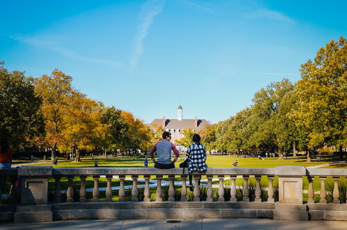 Two students with their backs to Foellinger, facing the Union side of the Quad