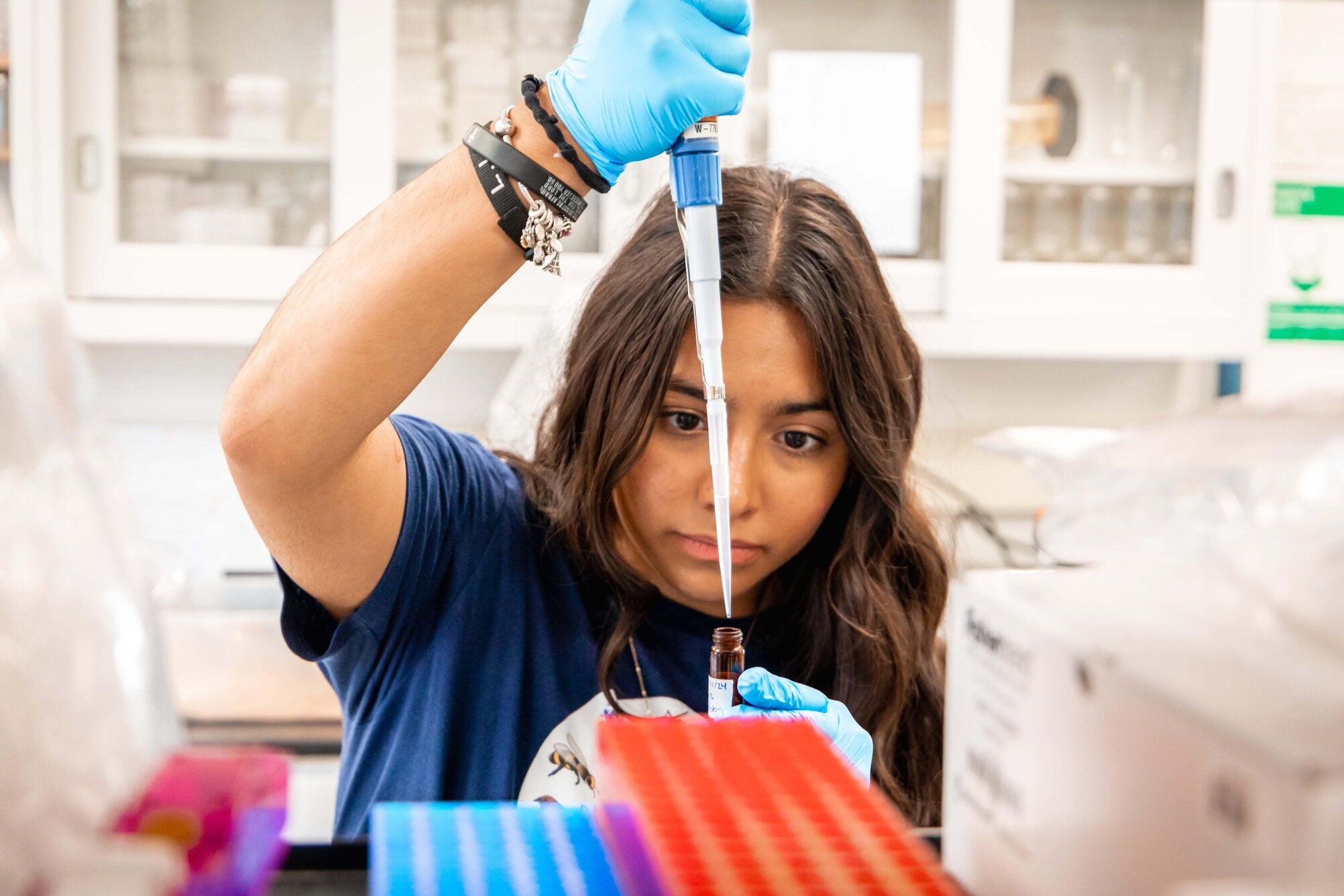 Student in a lab with a pipette 