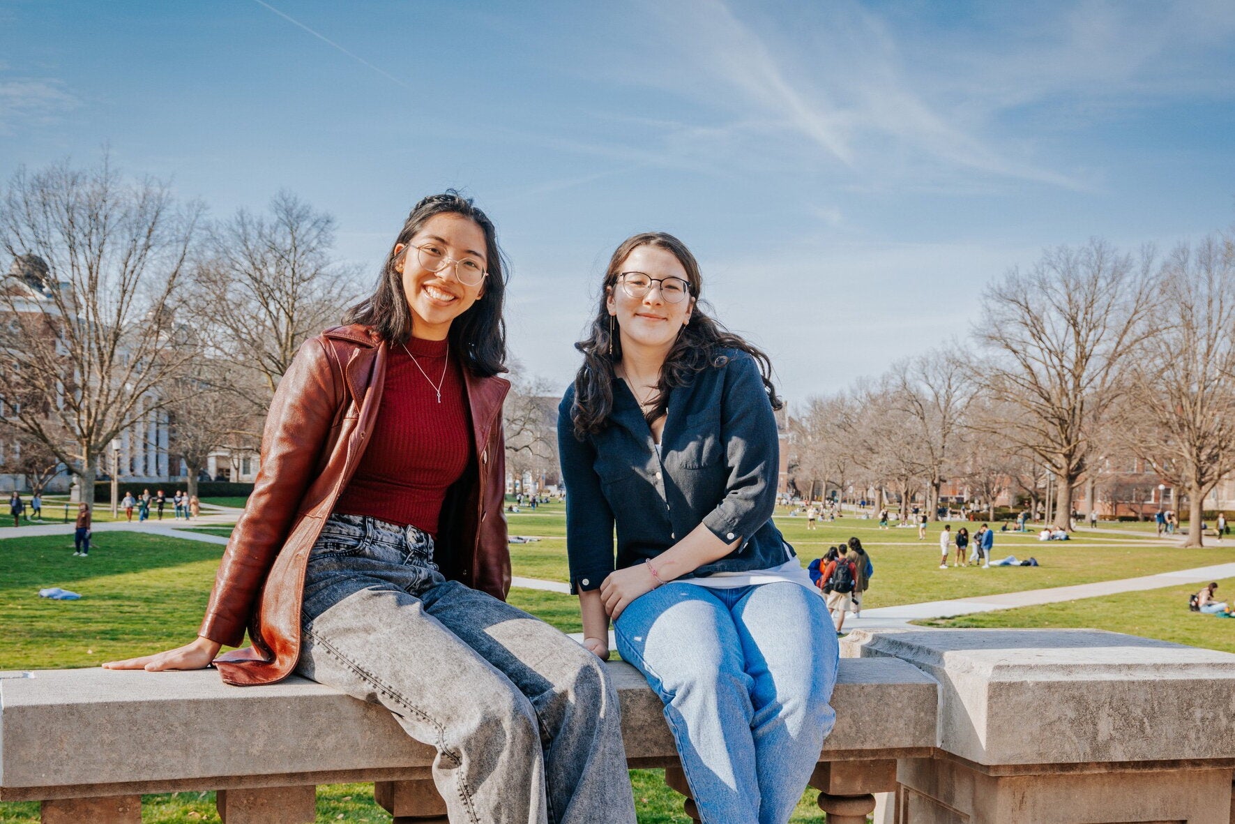 Students sitting in front of the Quad side of Foellinger Auditorium.