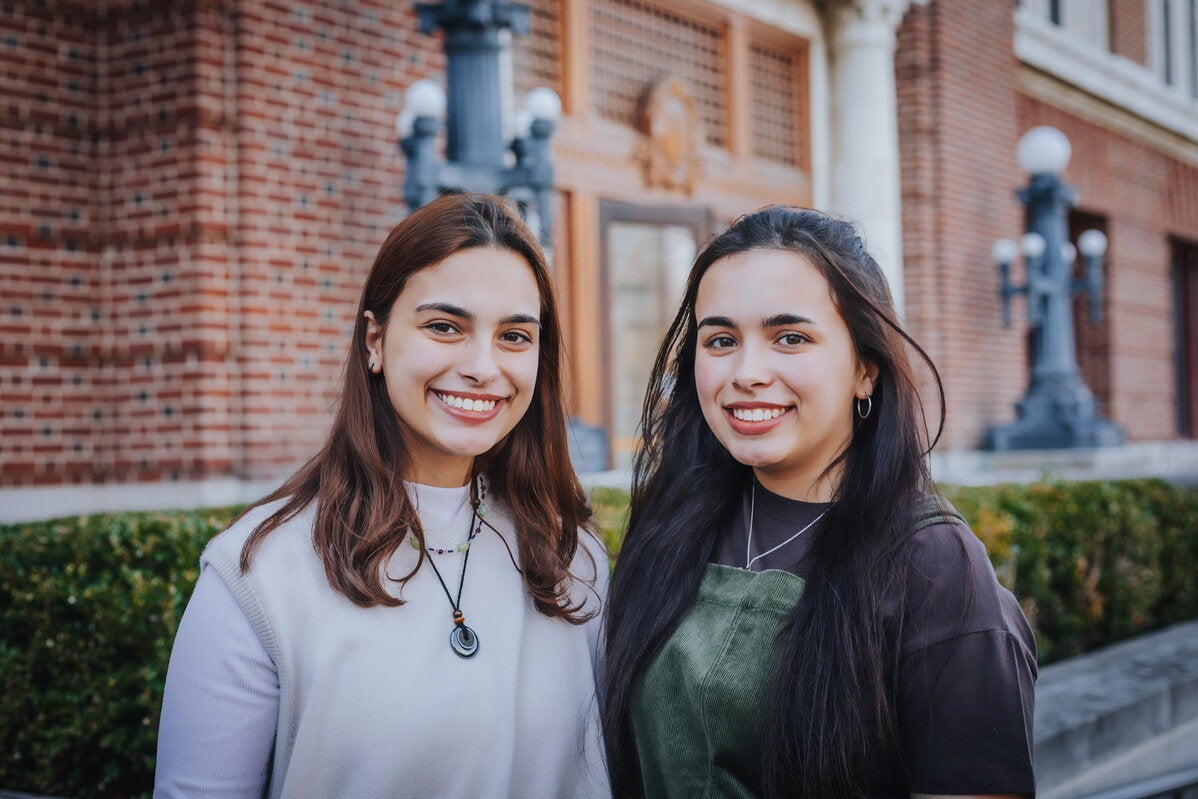 Two students standing in front of Lincoln Hall. 