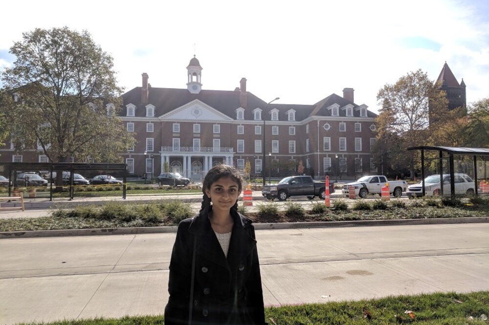 LAS student poses for photo in front of the student union
