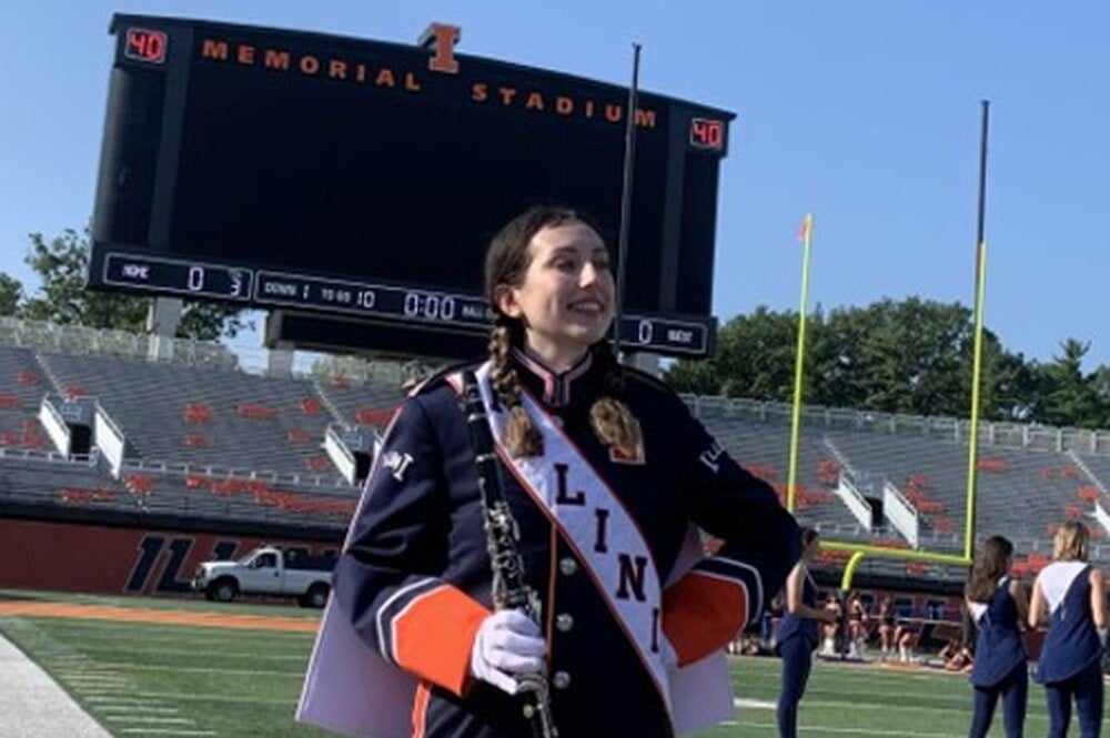 Student in Marching Illini uniform at Memorial Stadium