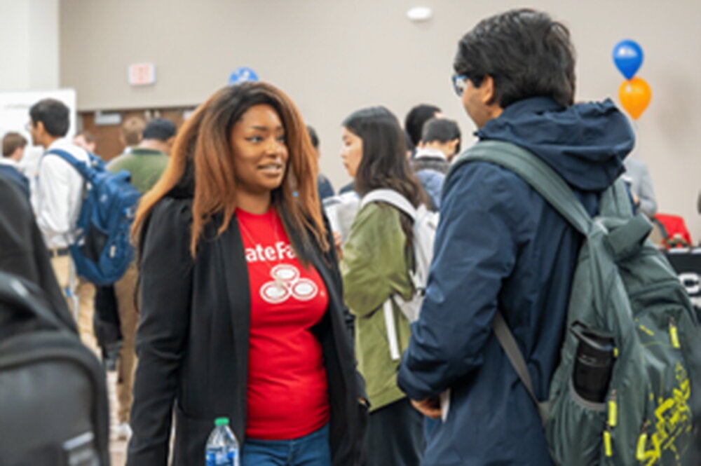 Student speaks to recruiter at career fair