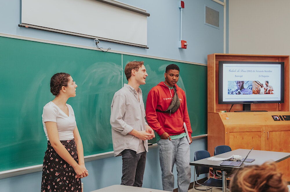 Students in the School of Literatures, Languages, Cultures, and Linguistics give a presentation in a classroom in front of a screen