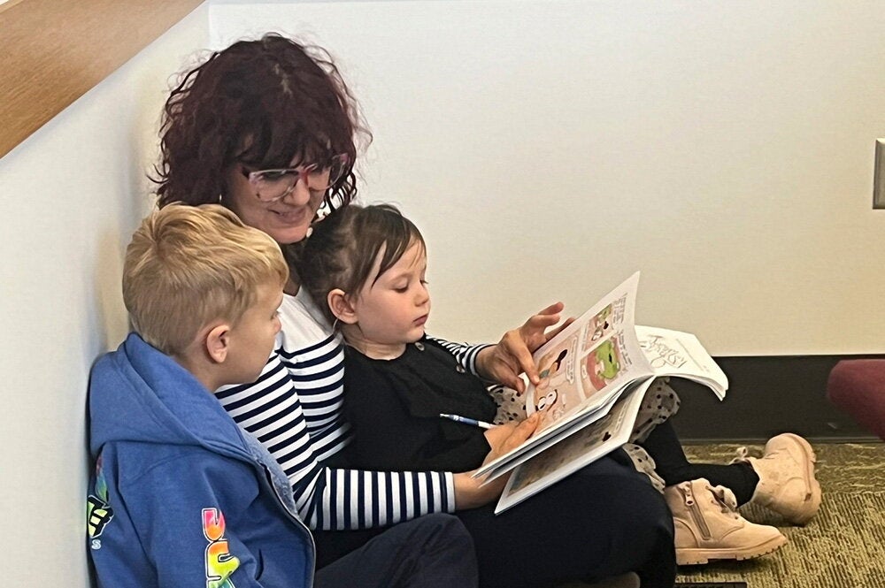 Children and a parent reading a book