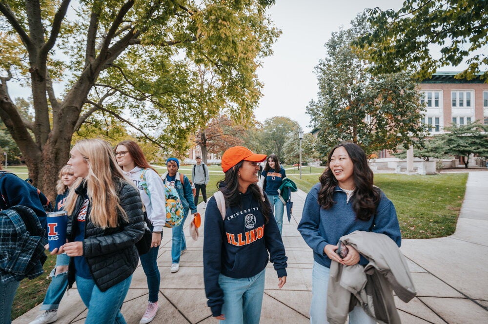 Students in Illinois gear walking down the Main Quad. 