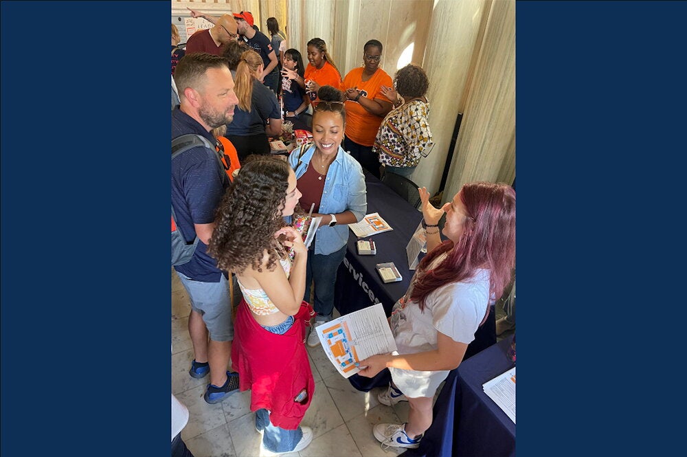 Colette Roth, at right, speaks with students in Lincoln Hall during Ilini Fest