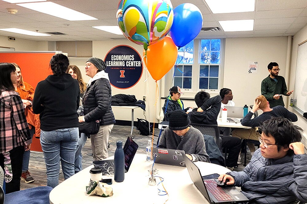 A crowd gathers in the Ralph Kiam Economics Learning Center