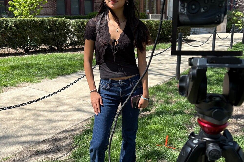 Ariana Dominguez standing in front of a camera on the Quad side of Lincoln Hall.
