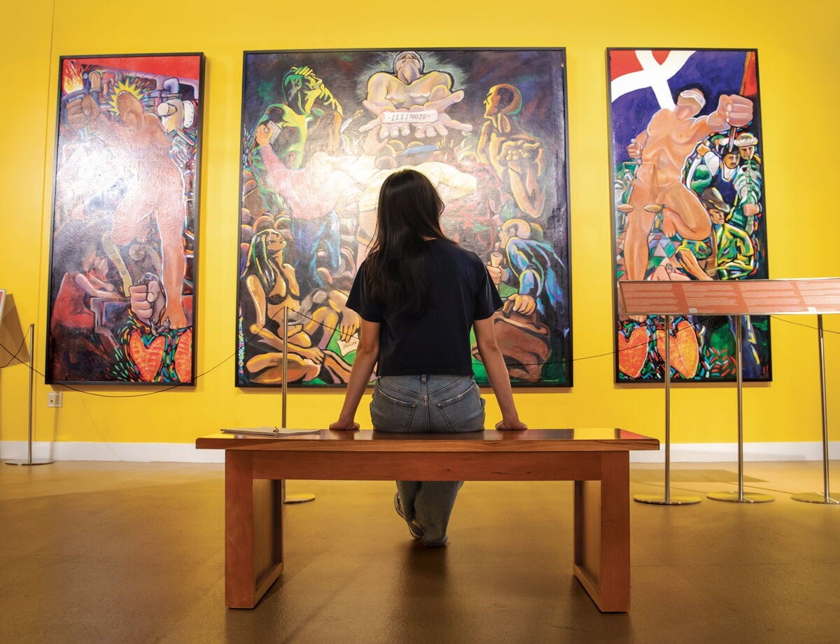 Student sitting on a bench at the Spurlock Museum. 