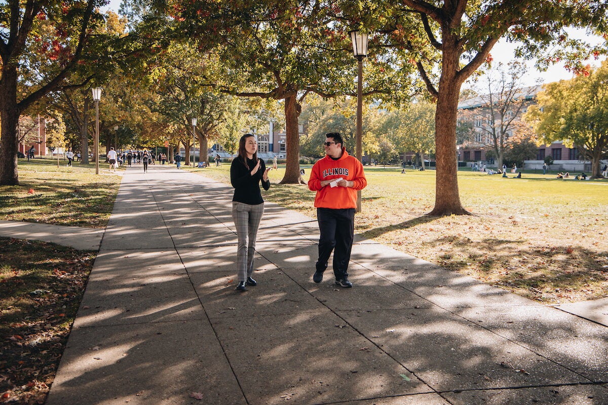 Student interviewing a professor on the Quad