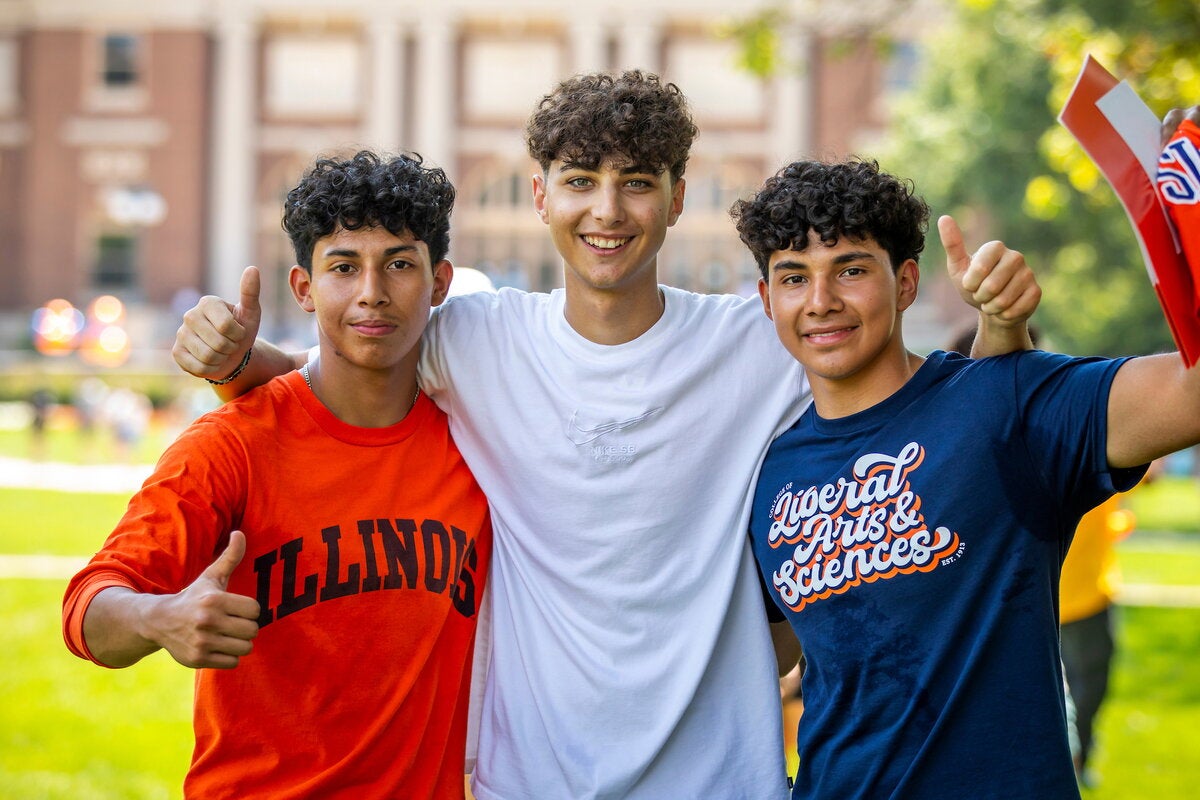 Students giving thumbs up signs on the Quad