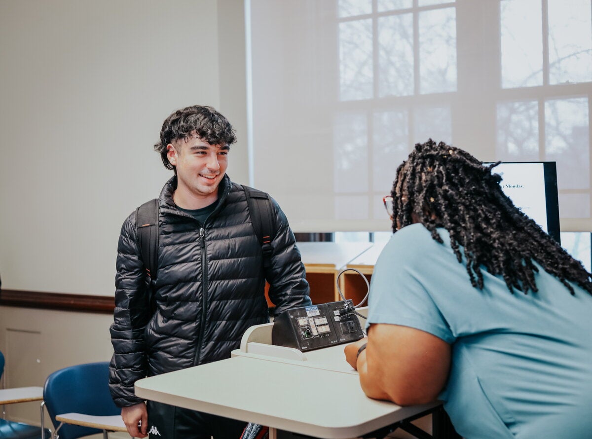Student speaking to instructor after class.