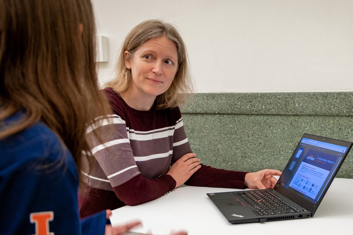 A staff member talks to a student