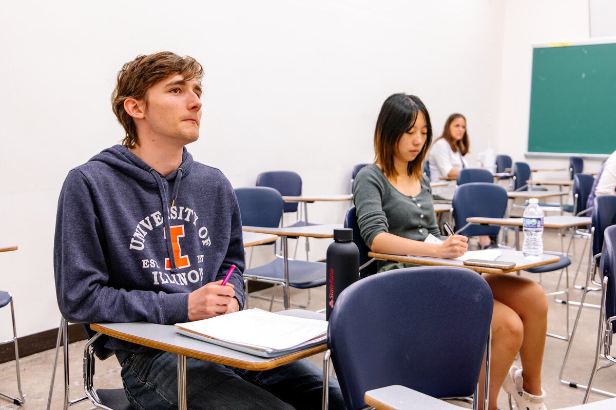 Students in a classroom participating in a discussion. 