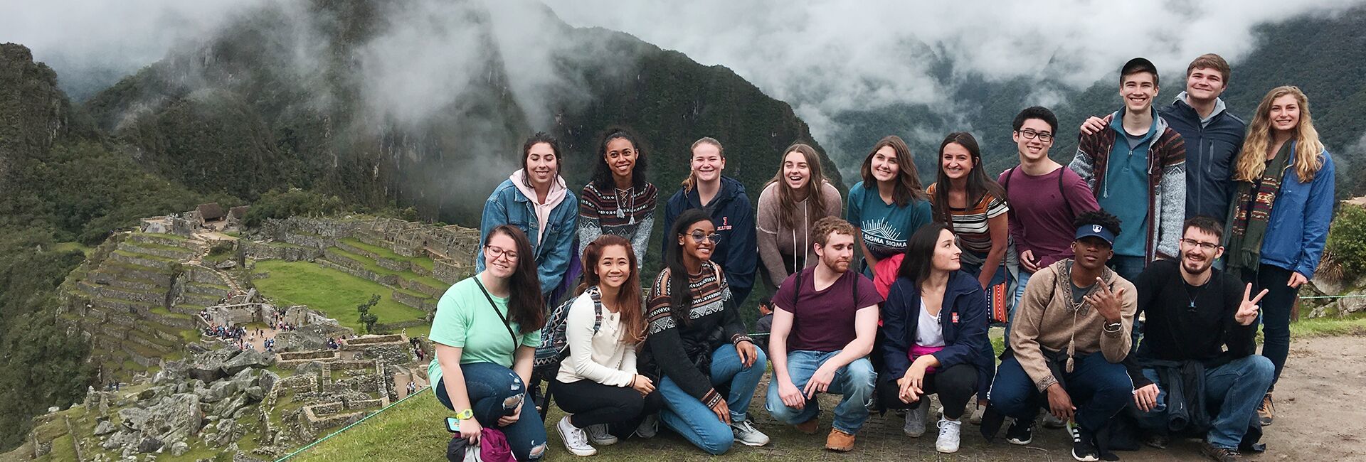 Students post at the top of Machu Picchu, Peru.