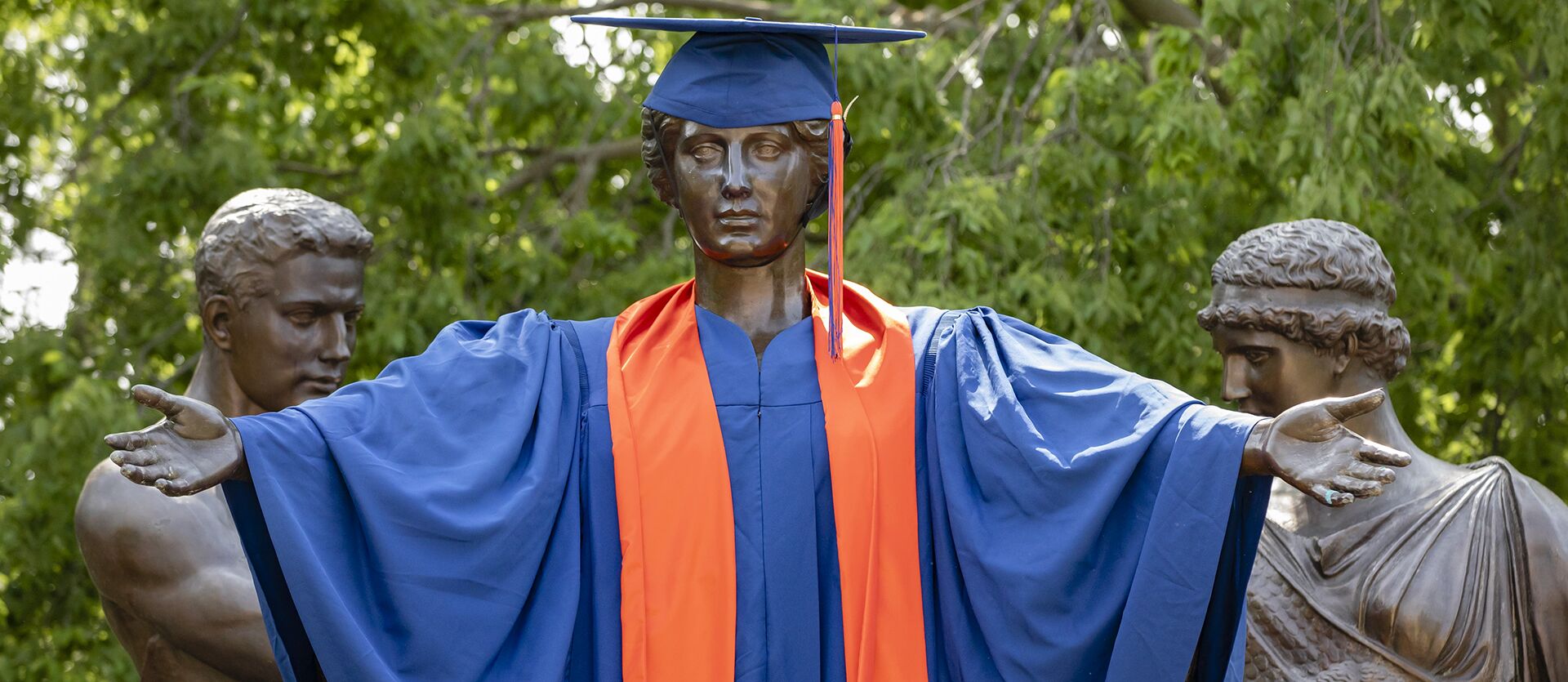 The Alma Mater statue, dressed in a blue and orange cap and gown
