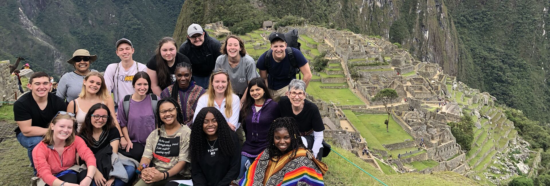 Students post at the top of Machu Picchu, Peru.