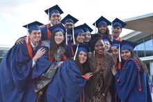 2024 GLP cohort pictured together in their blue caps and gowns at graduation