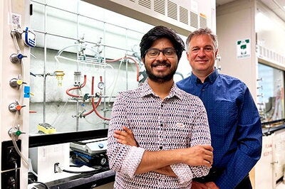 two people smiling in a lab
